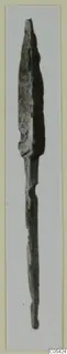 Corroded metal blade with a pointed tip and long narrow tang, from Marion