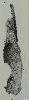 Heavily corroded iron tool from Marion, long and narrow with a thin tapering end