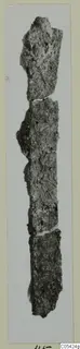 Corroded iron object from Marion, broken into several joined pieces, photographed upright on a pale card