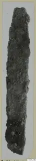 Long, narrow corroded iron tool from Marion, shown upright against a pale background.