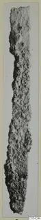 Corroded iron tool from Marion, shown upright as a long narrow blade on a card mount.