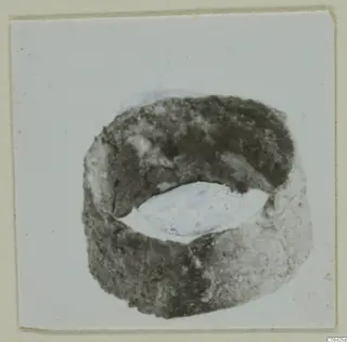 Bronze ring from Marion, Tomb 69, photographed on a pale card mount