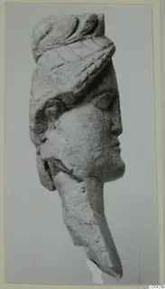 Limestone statuette head from Mersinaki, face in profile to the right, wearing a wrapped headdress