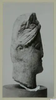 Limestone head from Mersinaki, shown in side profile on a stand