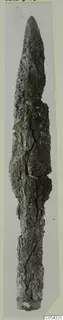 Corroded iron spear-head from Marion, Tomb 68, shown upright against a pale background.