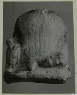 Limestone sculpture fragment from Mersinaki, a high-backed seat shape with a side block and a rounded projection.