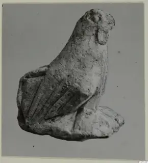 Limestone figurine from Mersinaki with a long neck, rounded head and parallel incised grooves on one side