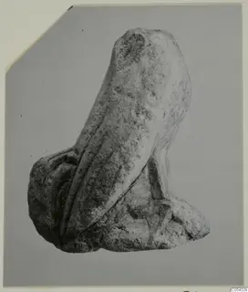 Limestone fragment of a small figure from Mersinaki, with parallel vertical grooves down one side