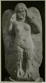 Stone statue of a standing female figure from Soli, arms raised to the head, shown against a dark background.
