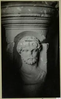 Carved stone head of a bearded man in relief below a moulded cornice, from Cyprus