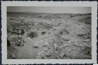 Excavated area at Idalion acropolis, with low stone walls and scattered rocks and rubble in dry ground