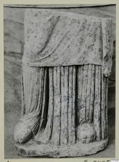 Carved stone sculpture fragment with draped folds, from Arsos