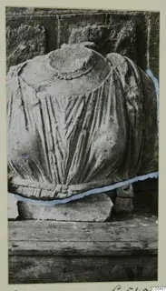 Stone statue fragment from Arsos with vertical drapery folds and a beaded band at the top