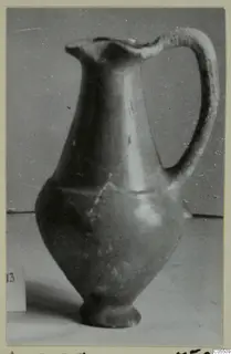 Red slip jug from Amathus, tombs 10–26, photographed against a grey backdrop