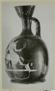 Pottery jug from Marion with a painted figure on its rounded body, photographed upright on a card mount