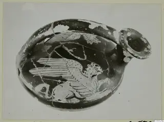 Guttus, a red-figure vessel with a winged animal painted on its rounded body