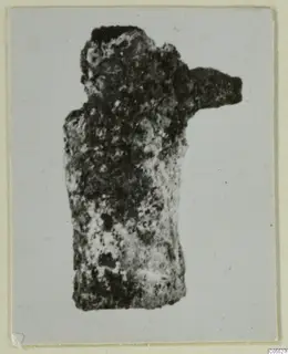 Corroded silver figure fragment from Marion, Tomb 40 B, with a single arm projecting to the right.