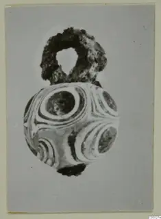 Spherical bead with concentric ring patterns and a corroded loop at the top, from Marion Tomb 92