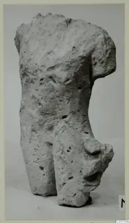 Fragment of a limestone figure's upper body and hips from Mersinaki, on a plain background