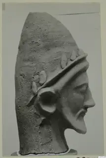Head of a bearded figure in profile, with a band of raised leaf-like ornaments around the brow, from Mersinaki.