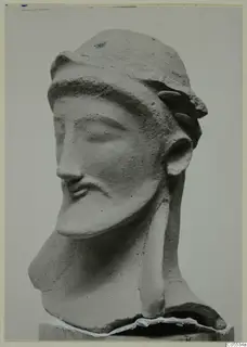 Terracotta head of a bearded man from Mersinaki, neck broken, standing on a wooden block