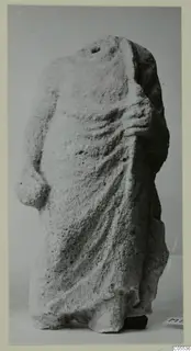 Headless draped limestone statue from Mersinaki, a standing figure with deep folds of cloth over the body