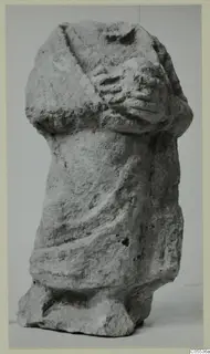 Limestone sculpture of a draped standing figure with arms folded across the chest, from Mersinaki