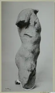 Limestone torso of a standing figure from Mersinaki, with head and arms missing.