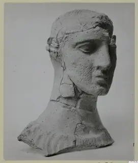 Head and upper torso of a figure from Mersinaki, pale clay, with cracks repaired