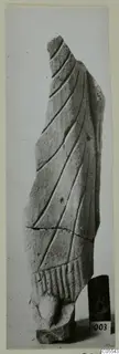 Broken limestone sculpture fragment from Mersinaki, carved with diagonal folds