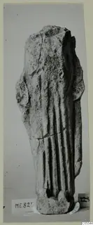 Limestone sculpture fragment from Mersinaki with vertical folds down the body, broken off at the top