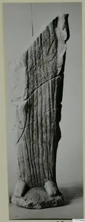 Limestone sculpture from Mersinaki with vertical grooves, a broken sloping top and two block-like feet at the base