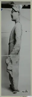 Side view of a standing limestone statue of a figure from Mersinaki