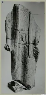 Limestone statue fragment from Mersinaki: a standing figure with head and forearms broken off, in a long garment with vertical folds.