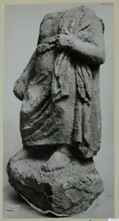 Headless draped stone statue from Mersinaki, arms held across the chest, standing on a rough block base