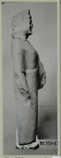 Standing limestone statue seen in profile, from Mersinaki