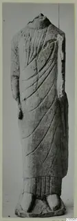 Headless limestone statue of a draped standing figure from Mersinaki, front view