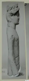 Limestone statue of a standing figure in profile, wearing a wreath, from Mersinaki
