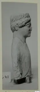 Limestone statue from Mersinaki, head and upper body shown in profile facing right, on a stone base