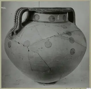 Black-on-Red amphora from Marion with concentric circle motifs and two strap handles, seen from the front.