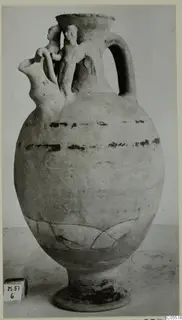 Pottery Polychrome jug with modelled figures on the neck and shoulder and dark painted bands on the body