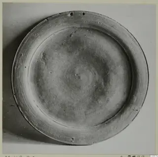 Pottery Stroke Polished Ware plate seen from above, with a raised ring inside its rim.