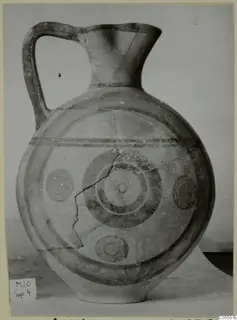 Pottery Black-on-Red I-III jug with one handle, a flared neck and painted concentric circles and bands