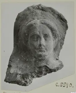 Fragmentary head with a relief face framed by a rounded covering, from Mersinaki