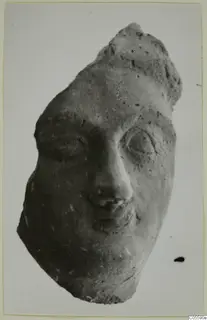 Terracotta head fragment with large eyes, nose and mouth, from Mersinaki
