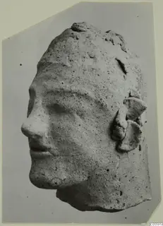 Terracotta head from Mersinaki, shown in three-quarter view facing left, with a rough, pitted surface and ear ornaments.