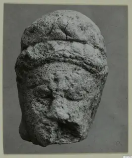 Limestone head from Mersinaki with a raised band across the brow and a broken nose
