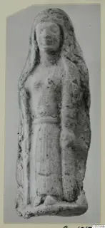 Standing figure with long hair and a belted garment, a small terracotta figurine photographed on a card mount