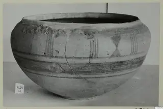Pottery Polychrome Lustrous Foreign bowl with painted bands and vertical strokes, shown on a plain surface