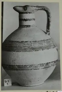 Pottery Bichrome IV jug (S.4.4) with a beak-shaped spout, strap handle and dark painted bands